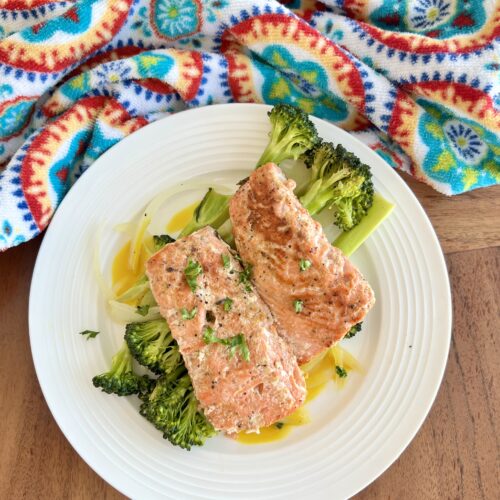 honey mustard salmon on a white plate with steamed broccoli