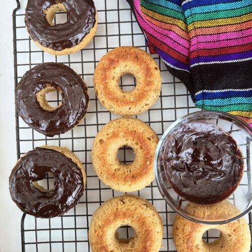 glazing donuts on a cooling rack