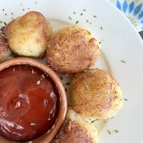 picture of papas rellenas on a plate with ketchup